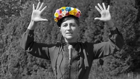 Ulrike Almut Sandig Ulrike Almut Sandig steht vor einem Mikrofon, beide Händen nach oben gestreckt